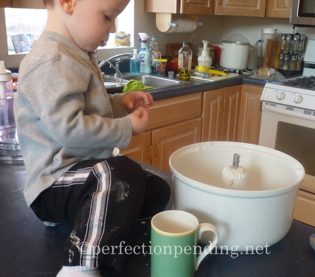 © boy helping mom cook