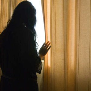 woman looking out window