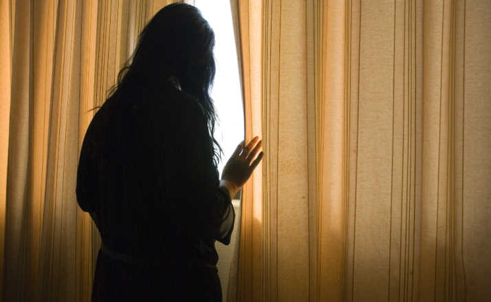 woman looking out window