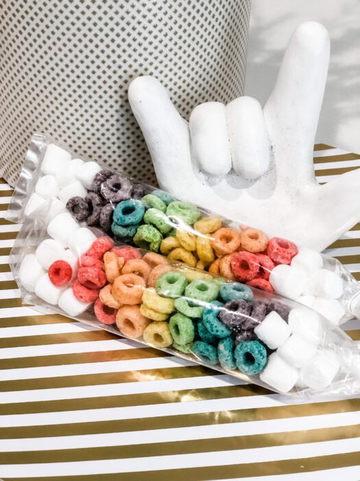 I love you clay hand, rainbow froot loop treats with marshmallows on gold and white background