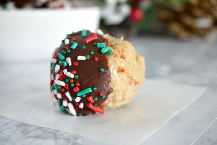 These peanut butter balls are the perfect no bake Christmas treat to give out to neighbors. They are a fast Christmas dessert idea that look festive, and combine the favorite flavors of peanut butter and chocolate. The best part, is that it is a Christmas treat idea that comes together in 30 minutes. #christmastreat #christmasdessert #neighborgifts #giftideas #peanutbutterballs #chocolateandpeanutbutter