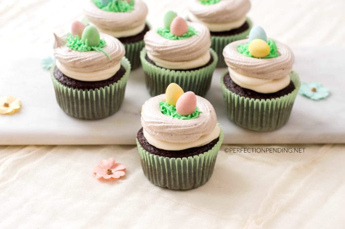 These chocolate cupcakes with a meringue bird's nest are perfect for your Easter party or Spring fun. With buttercream grass and bright colorful easter eggs, these fun Meringue Robin's egg nests make the perfect addition to your Easter chocolate cupcake. #Eastercupcakes #birdnestcupcakes #springcupcakes #Easterdessertidea