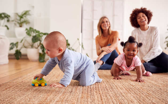 Two Mothers Meeting For Play Date With Babies At Home In Loft Apartment