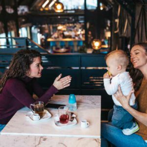 two mom friends enjoying coffee