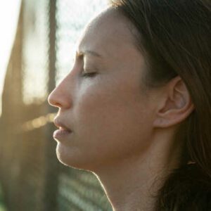 A woman taking a break outside at the end of the day, closing her eyes and taking a breath I never get a break from my child