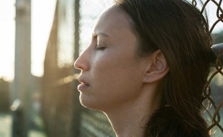 A woman taking a break outside at the end of the day, closing her eyes and taking a breath I never get a break from my child